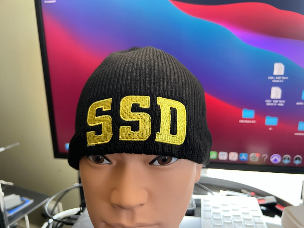 Black New Era Knit beanie hat with Solid Yellow SSD logo