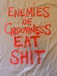 Image 1 of ‘Enemies’  white T Shirt with fluro uv active  orange text (size 26 70s style chest 120cm)