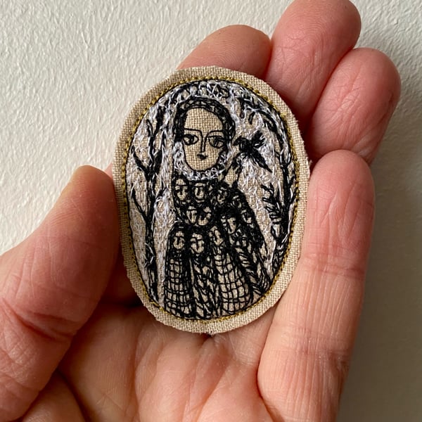 Image of Woman with winter bird - smaller embroidery portrait brooch 