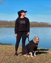 WEARS BLACK LOVES DOGS AVOIDS PEOPLE