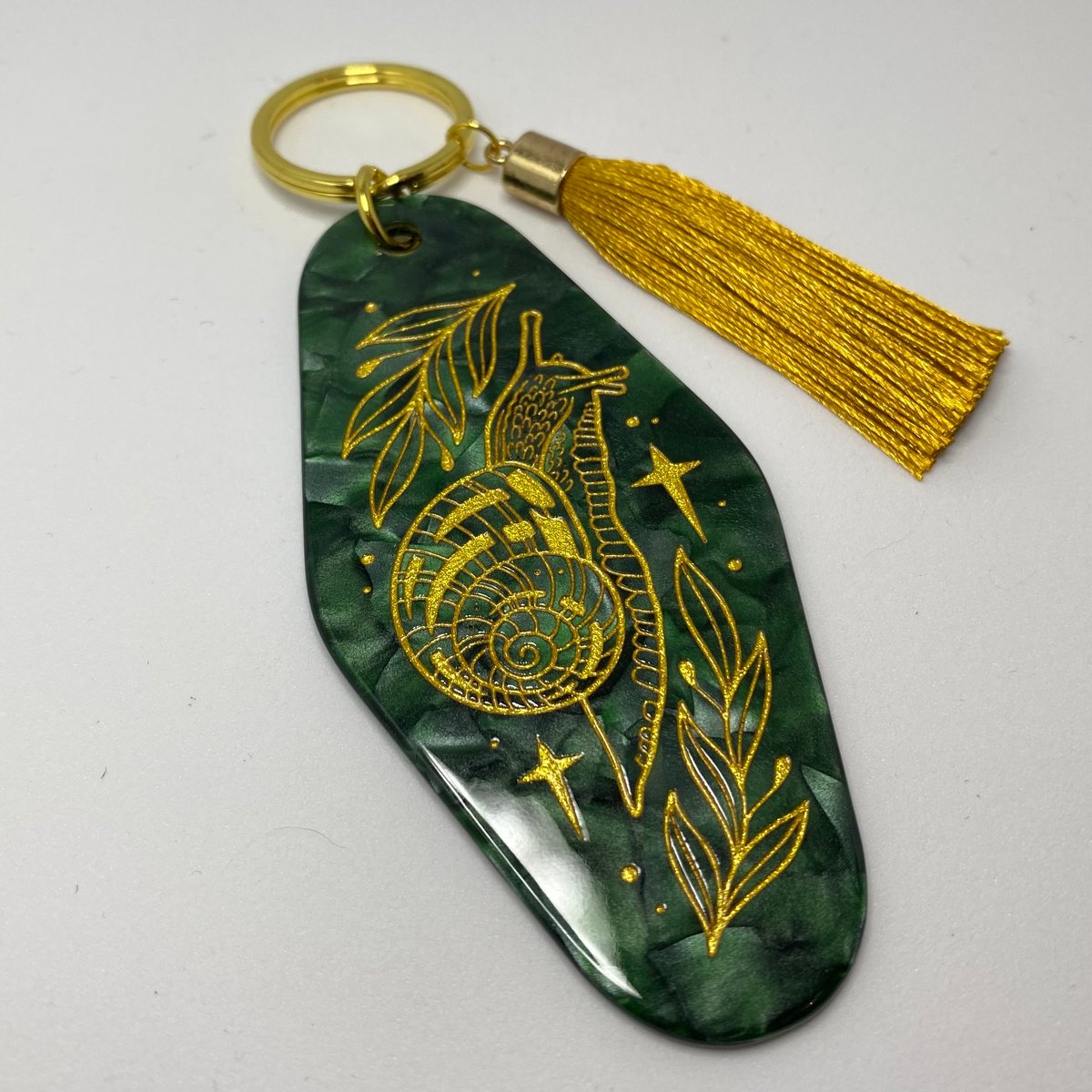 Motel green and gold snail keyring 