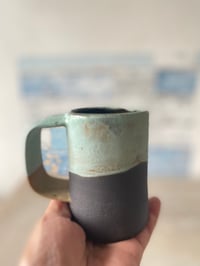 Image 3 of Black clay mug.