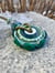 Image of teal flow; effetre medallion with accent beads and leather cord