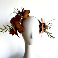 Image 1 of Tan bilateral flower headpiece. 