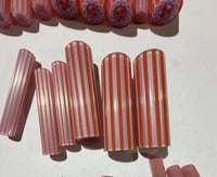 Image 4 of Orange and milky blue stripes with a UV center 
