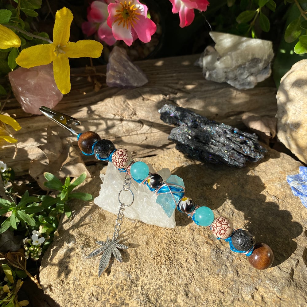 Image of aqua flower roach clip