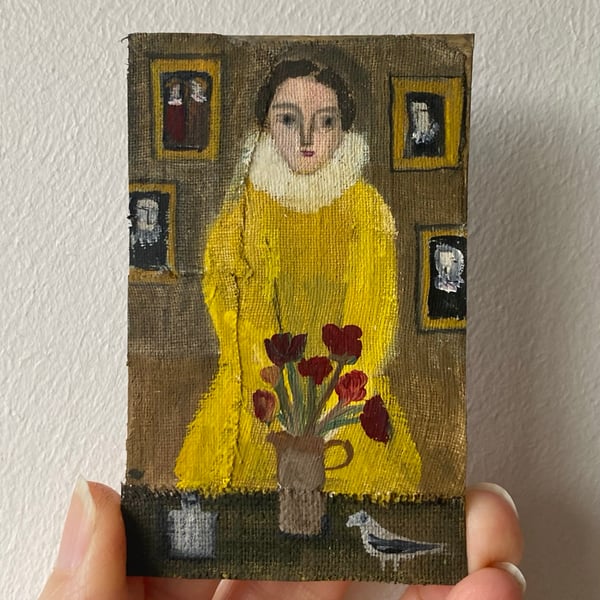 Image of Woman in gold with deep red flowers 