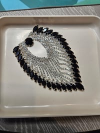 Image 3 of This is a decorative rhinestone applique featuring a teardrop or wing-like shape. 