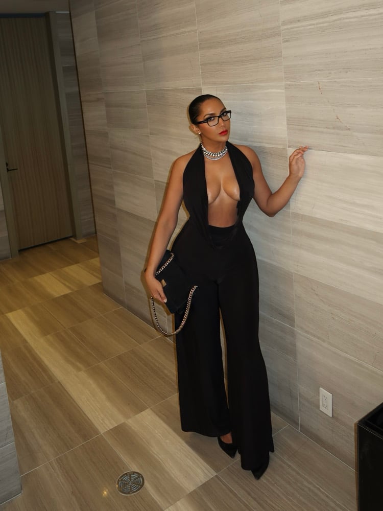 Image of BLACK LOW CUT HALTER FLARED JUMPSUIT (M)