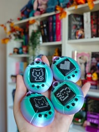 Image 1 of Tamagotchi Clickers arcoiris y negro llavero 