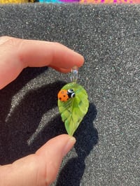 Image 1 of Green Leaf W/ Orange Bug Eyed Leadybug pendant 
