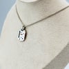 Enamel and sapphire tag 