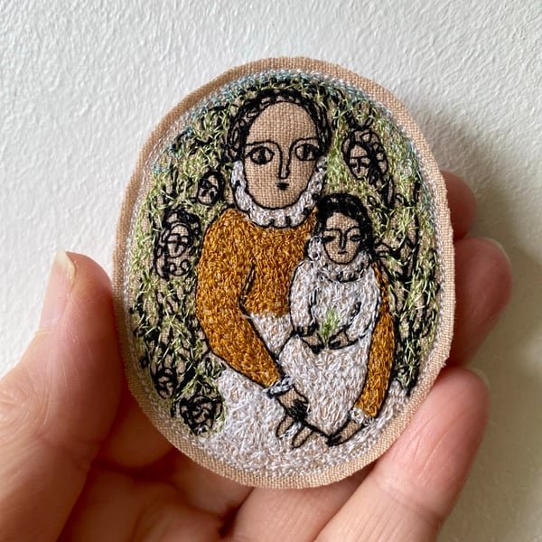 Image of woman and child, in a garden - embroidery brooch