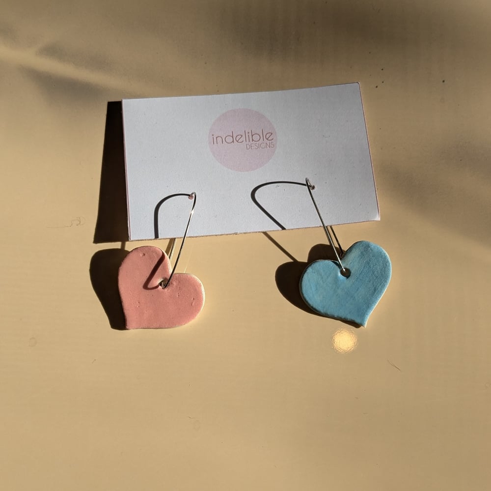 Image of pink and baby blue heart asymmetrical earrings