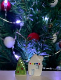Image 6 of Little House with lights and a Christmas Tree.