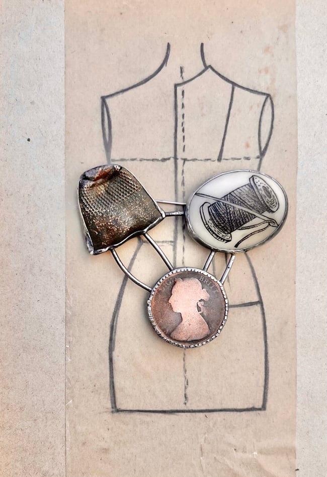 THIS WOMAN’S WORK BROOCH 