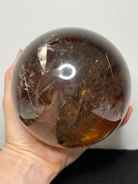 Image 18 of Golden Rutile In Smoky Quartz Sphere #1770