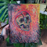 Image of skull on cardboard (blacklight)