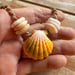 Image of Hawaiian sunrise or moonrise shell necklace with golden pukas and a locking seaglass clasp