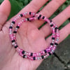 pink and black beaded bracelet 