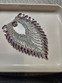 Image 4 of This is a decorative rhinestone applique featuring a teardrop or wing-like shape. 