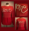 Upcycled “love” cursive yarn sweater in tri-color red