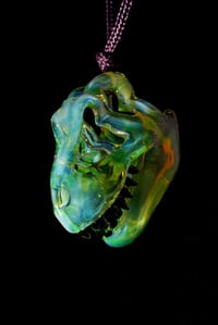 Image 2 of Fully uv reactive green slyme mini T-Rex skull pendant. 💚
