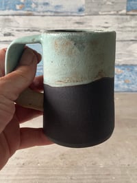 Image 4 of Black clay mug.