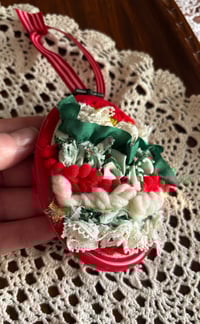 Image 1 of 3” Abstract ornament using red, green, and gold fibers 