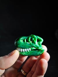 Image 2 of Chromium T-Rex skull pendant with glowin glass glow in the dark teeth.