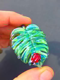 Image 1 of Drippy UV variegated monstera leaf with ladybug pendant. 🐞🌿
