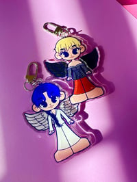 Image 2 of jimin and tae winged keychains.