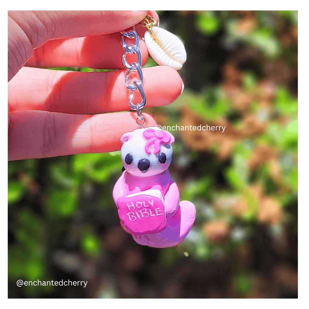 Image of Coquette Sea Otter Holding Bible Keychain