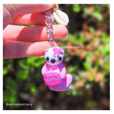 Image of Coquette Sea Otter Holding Bible Keychain