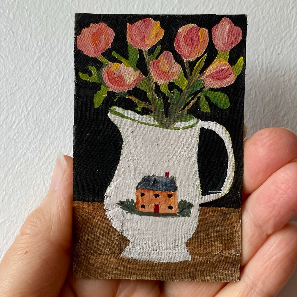Image of pink-peach roses in a cottage jug