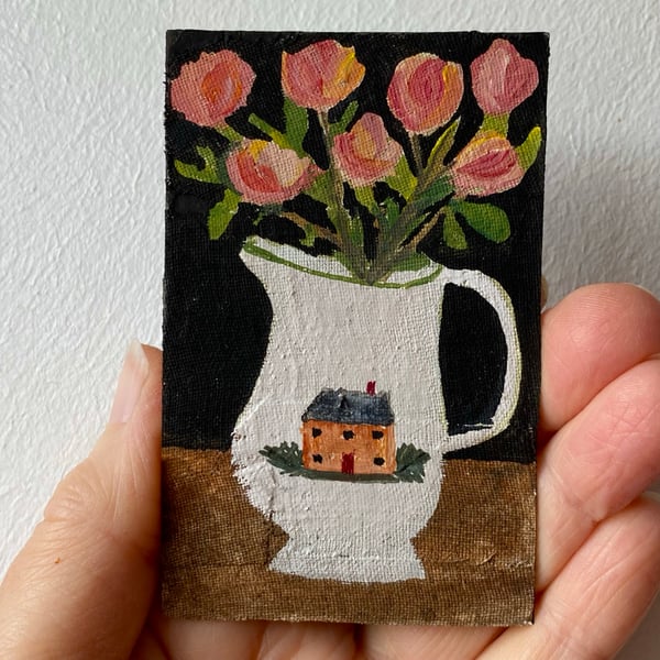 Image of pink-peach roses in a cottage jug