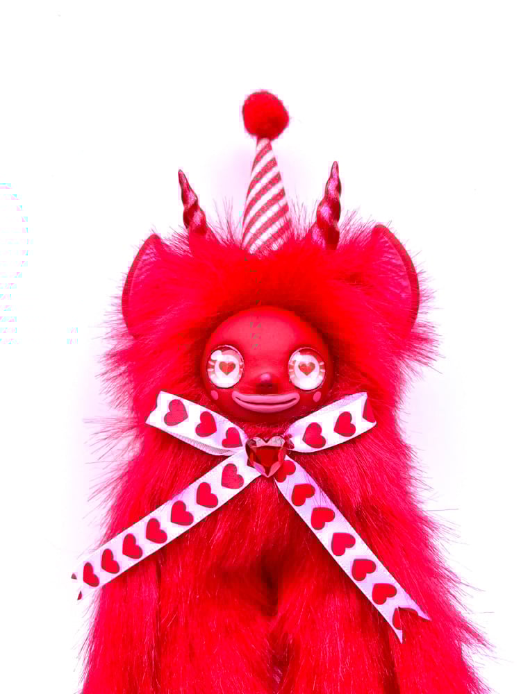 Red Creature with white bow 