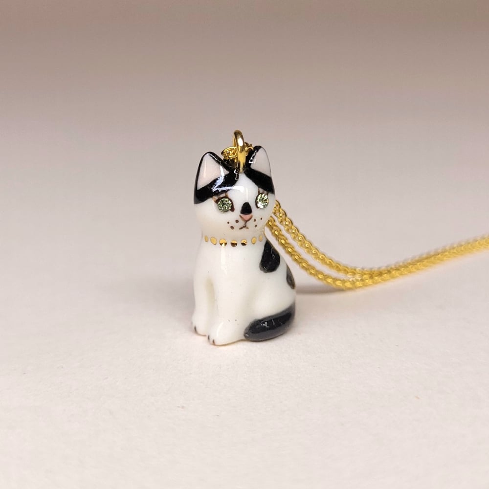Image of Cow Cat Porcelain & Gold Vermeil Sitting Kitten Pendant