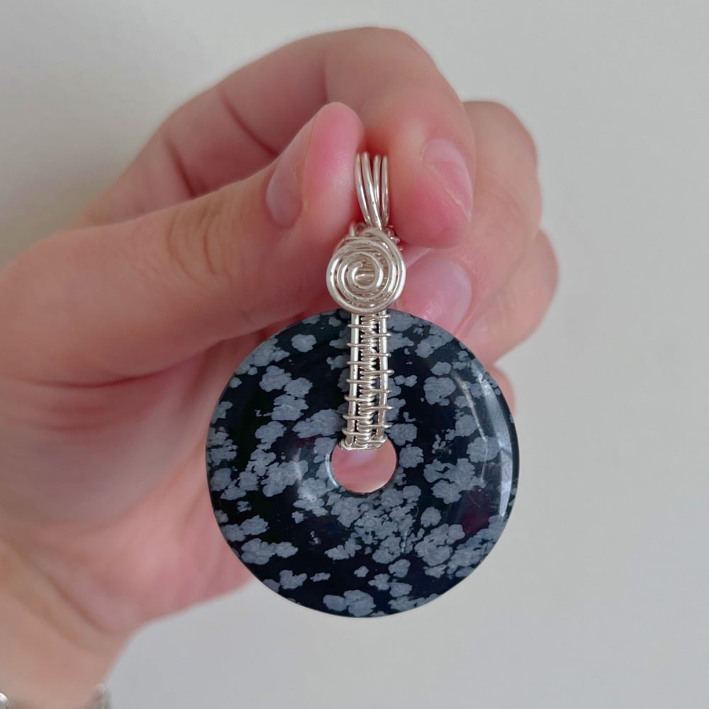 Image of snowflake obsidian fidget spinner pendant
