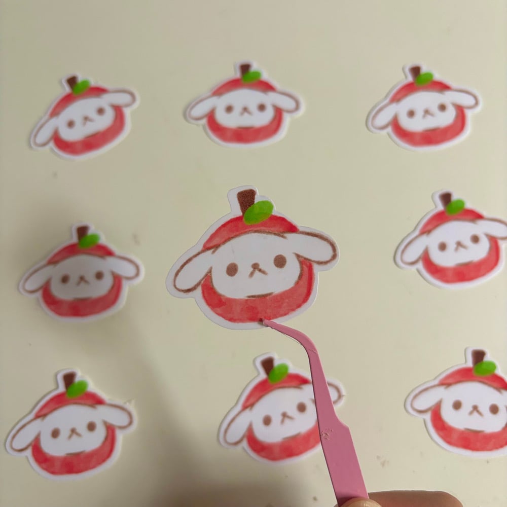 Image of Happy wearing apple hat sticker
