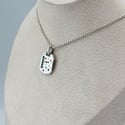 Enamel and sapphire tag 