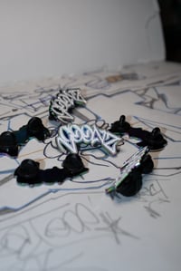 “Goonz” Iridescent Tag Pin 🫗