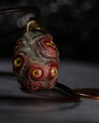 Image 2 of Egg of the King pendant, leather cord, brass hardware, all seeing glowing eyes