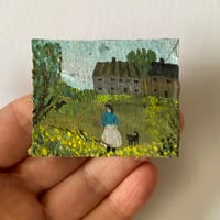 A girl and her cat in a spring landscape 