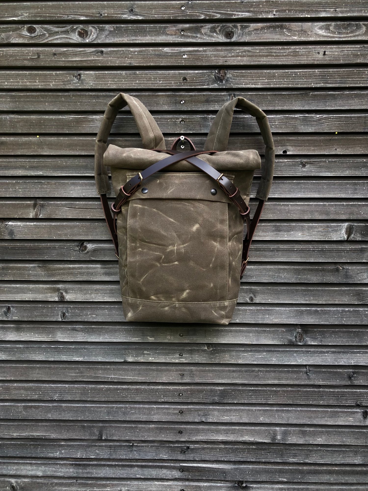 Image of Field tan backpack medium size rucksack in waxed canvas, with volume front pocket and double layered