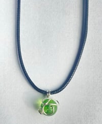 Image 2 of Swirling green planet