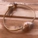 Image of Snake’s head cowrie bracelet on hand braided sinew, your size