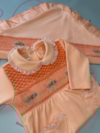 Image 1 of girls peach smocked babygrow 