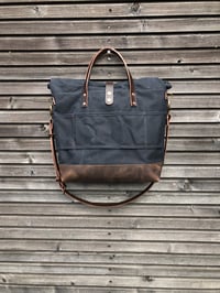 Image 4 of Black waxed canvas roll to close top tote bag with luggage handle attachment 