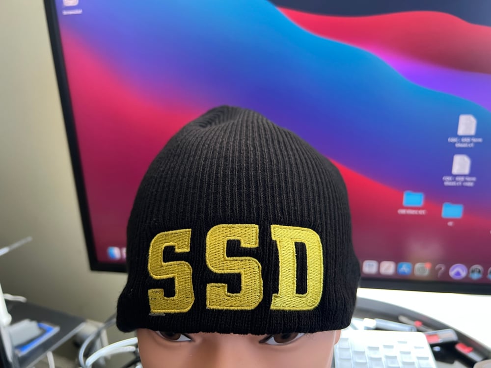 Black New Era Knit beanie hat with Solid Yellow SSD logo